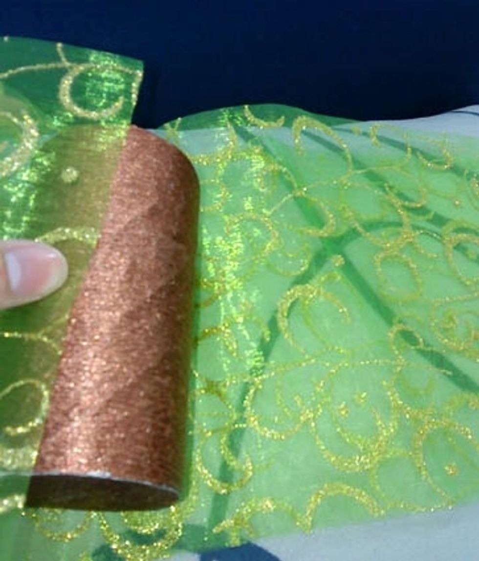 Wrap the fabric around the roller using glue