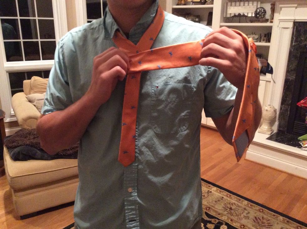 Wrap the fat end underneath and to the right and then over to the left