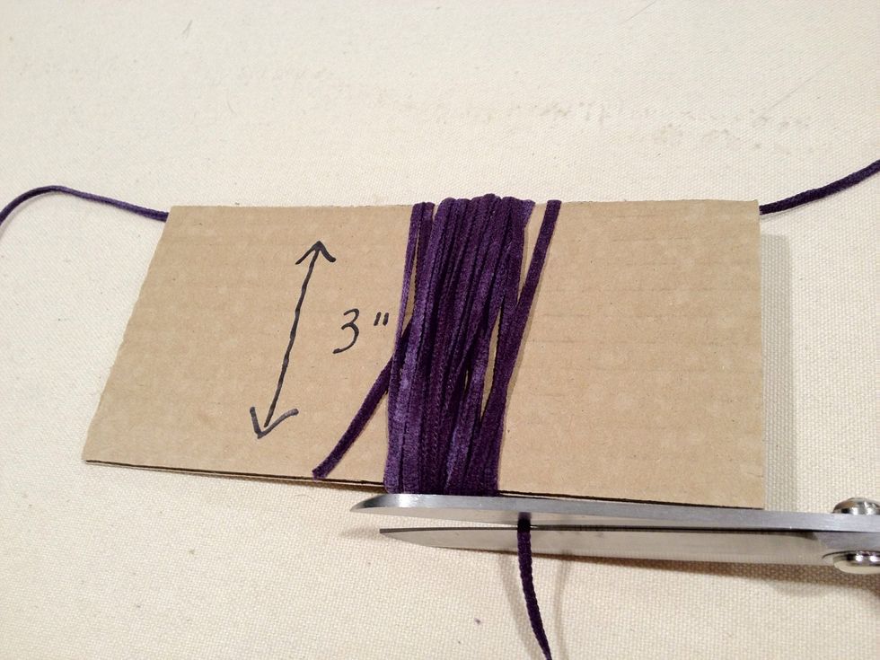 Wrap the first color yarn around the cardboard about 20 times.