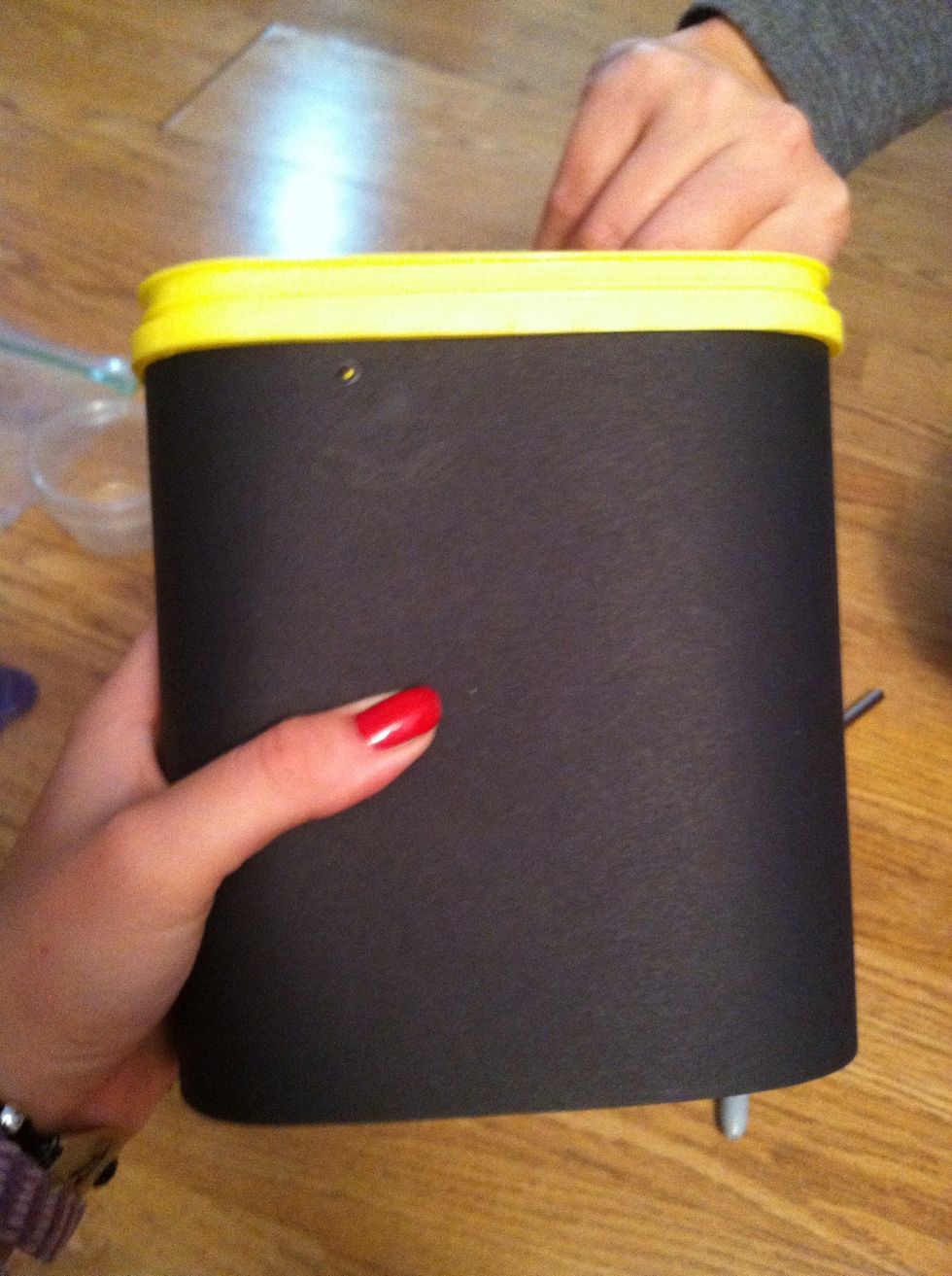 Wrap the largest piece of paper around the box. Their should be a gap in the back.