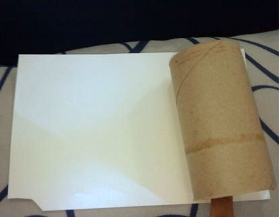 Wrap the paper around the roller using any kind of glue