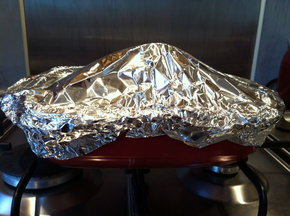 Wrap the Pork in foil, be careful as the dish will be very hot, this is to stop the top from burning too much while you cook the rest of the meat..