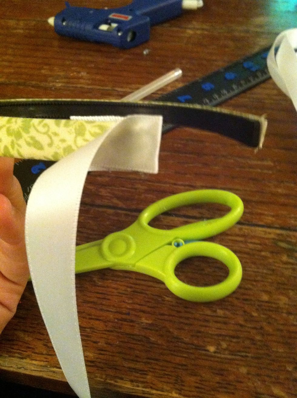 Wrap the ribbon around and press firmly, securing the ribbon about a half in up.