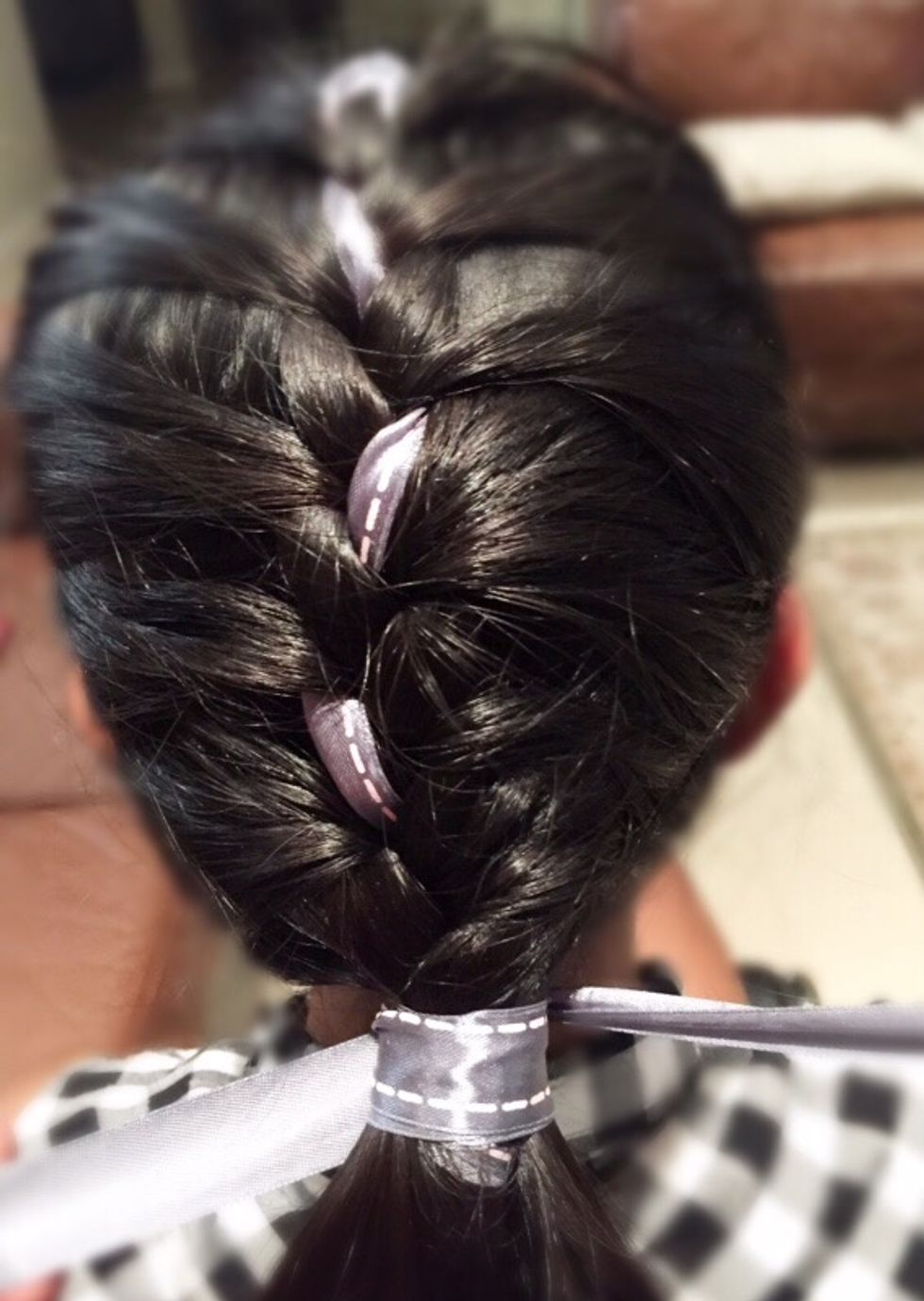 Wrap the ribbon around the bottom of your hair, and then tie a bow.