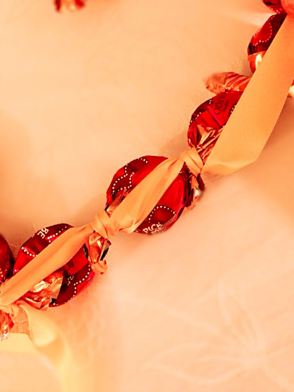 Wrap the ribbon in between the candy