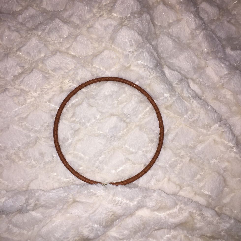 Wrap the ring in in leather cord all the way around.