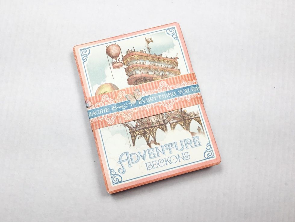 Wrap the strip around the album as shown. Do make it to tight, it\u2019s needs to be able to slide on and off the album easily.