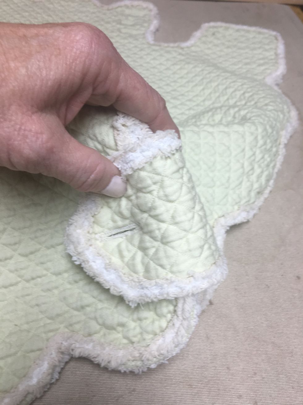 Wrap the tab around the front corner and mark the button placement through the button holes with a pencil as before and attach the buttons to the slip front corners the same way.