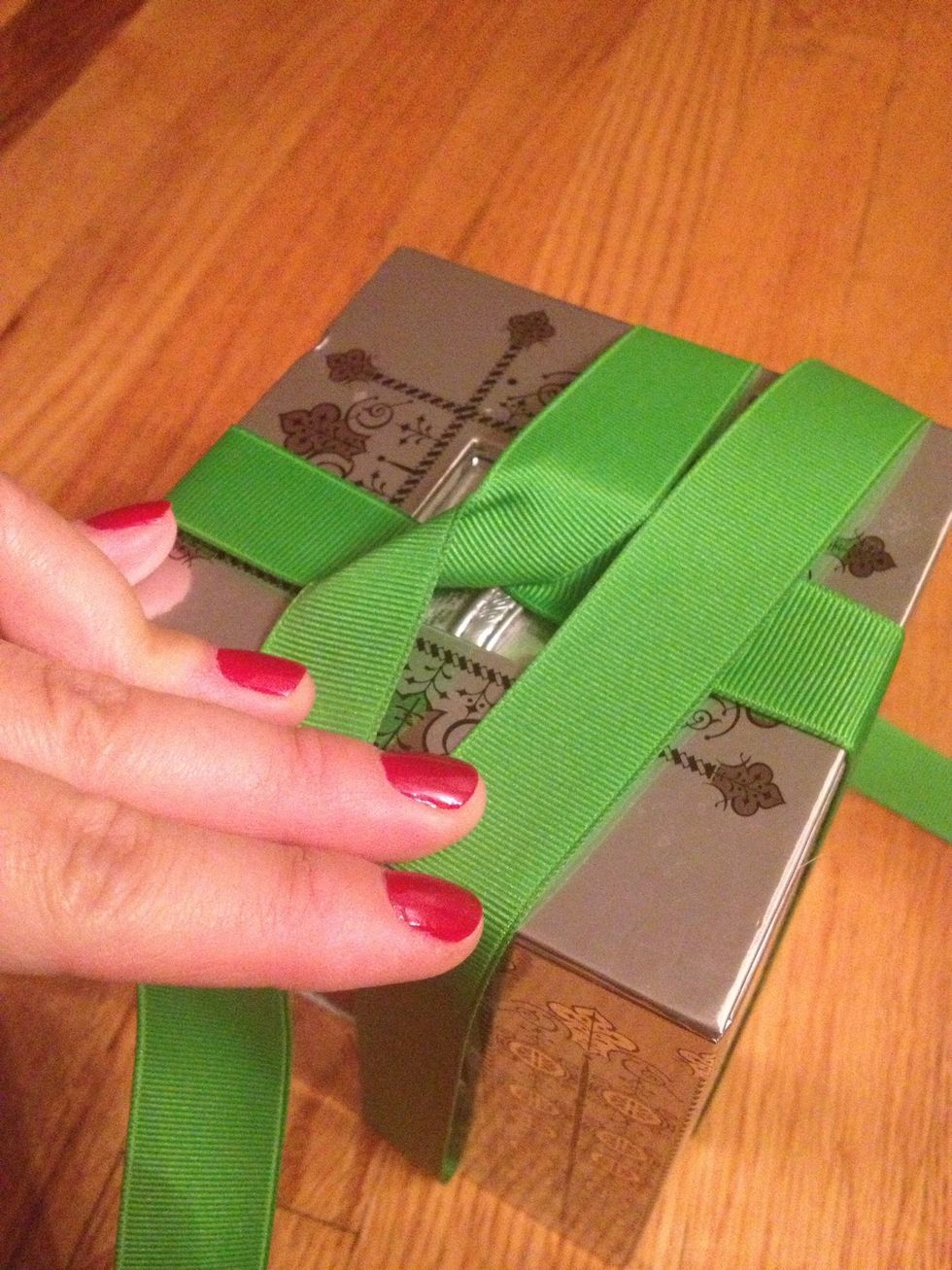 Wrap the tail end of the ribbon around the box once again and this is now what the top of the box should like.