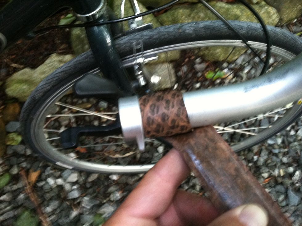 Wrap the tape backwards against the end of your bar, then begin wrapping up the bar.