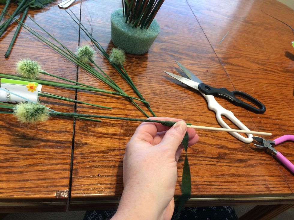 Wrap the tape down the stem. When at the bottom, add a dowel to increase the length of the piece. Secure with tape and wrap all the way down the dowel.