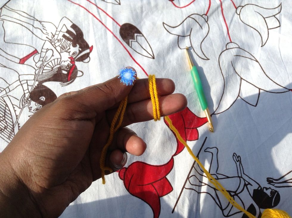 Wrap the working yarn under and over your index and middle fingers as shown. **Please excuse blue fireworks, I'm in desperate need of a manicure. :-(