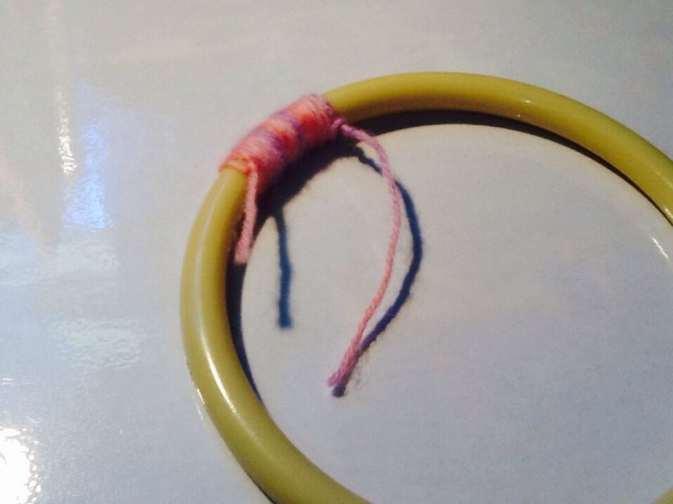 Wrap the yarn around and around the hoop, making sure that it is tight, and not overlapping either. You can wrap the yarn in sections, as this will be more secure, and tighter.