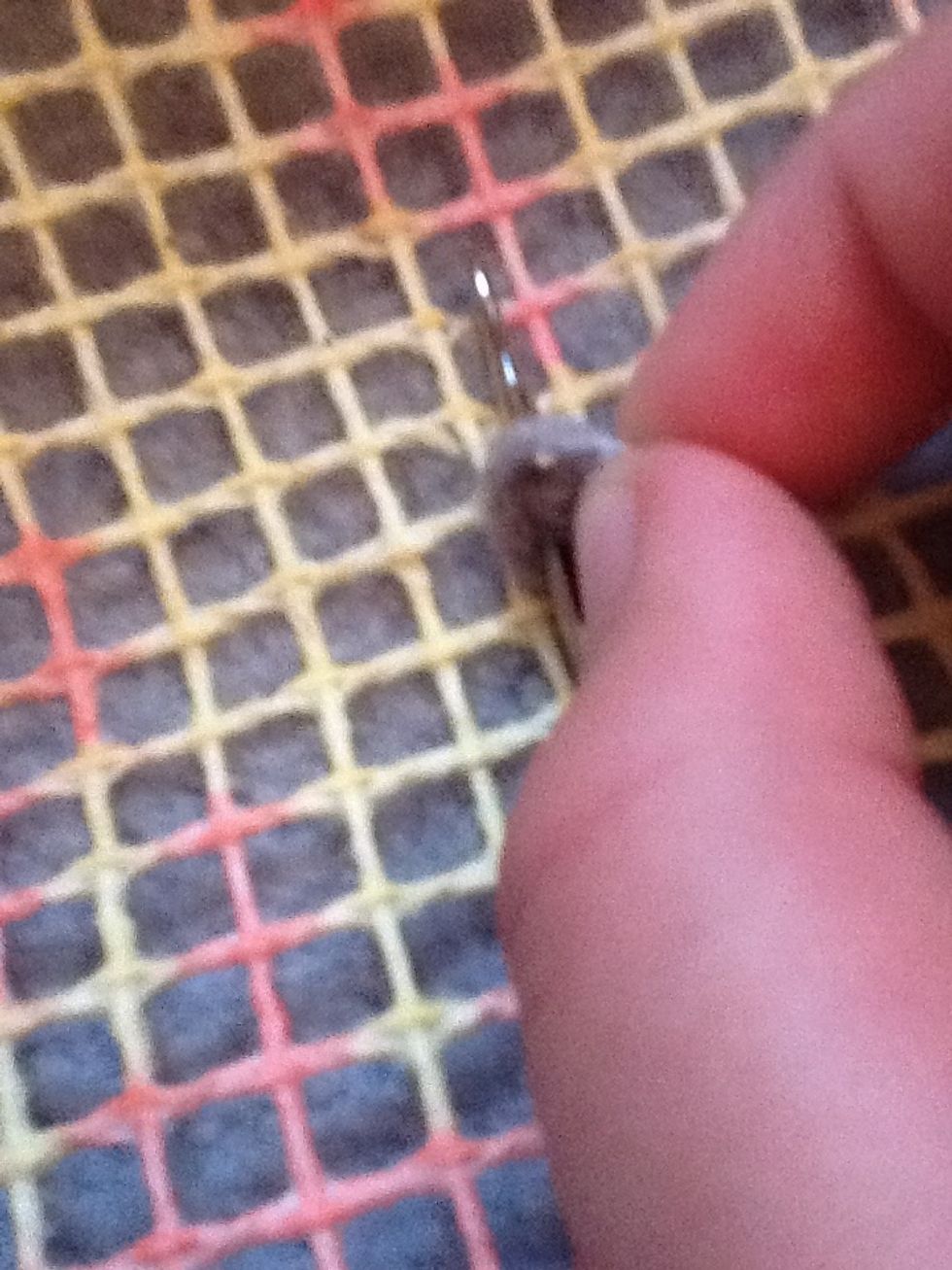 Wrap the yarn around the bit that stocks up (I'm not sure what its called)