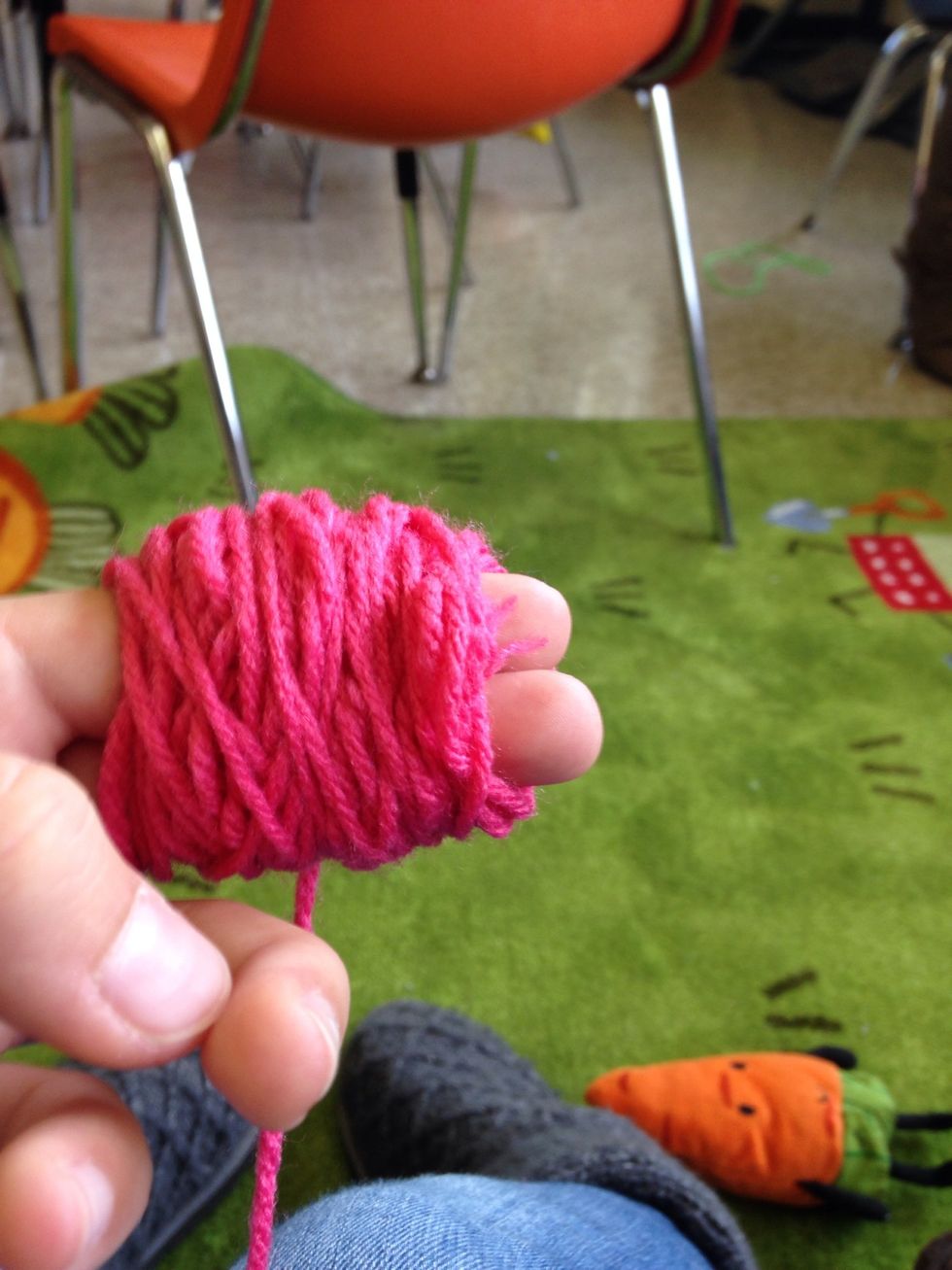 Wrap the yarn around your middle and index finger 100 times