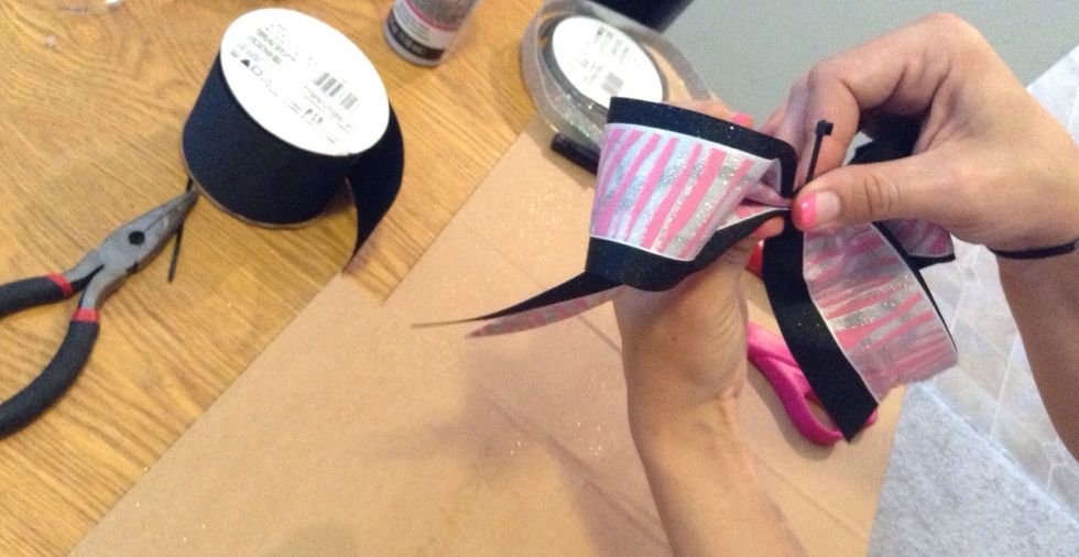 Wrap the zip tie around the center and pull tight.