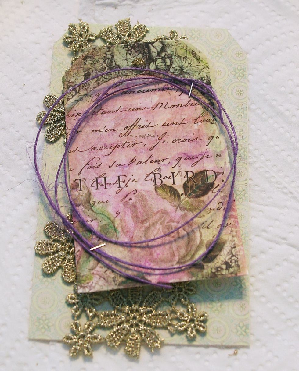 Wrap thread around hand three times and staple to tag as shown.