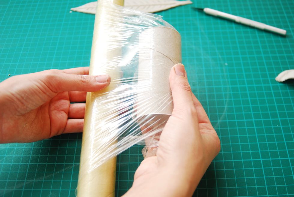 Wrap toilet roll in plastic wrap.
