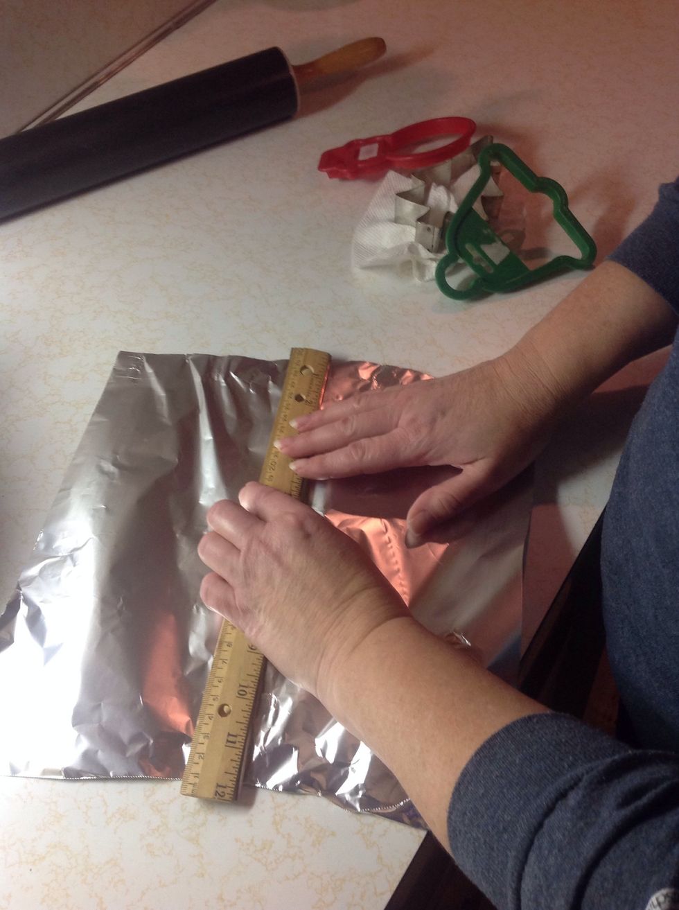 Wrap two rulers together with tin foil. Do this twice.