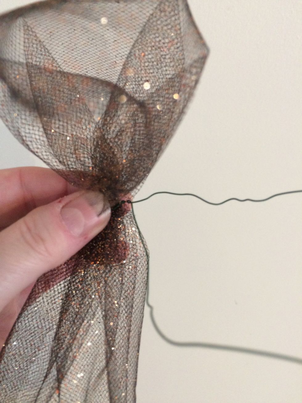 Wrap wire around the tulle then twist the wire.