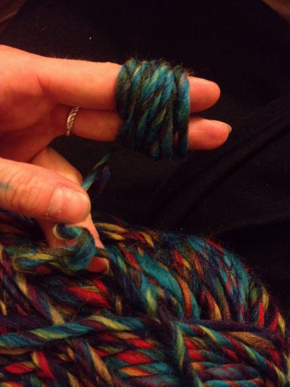 Wrap wool around fingers about 12 times.