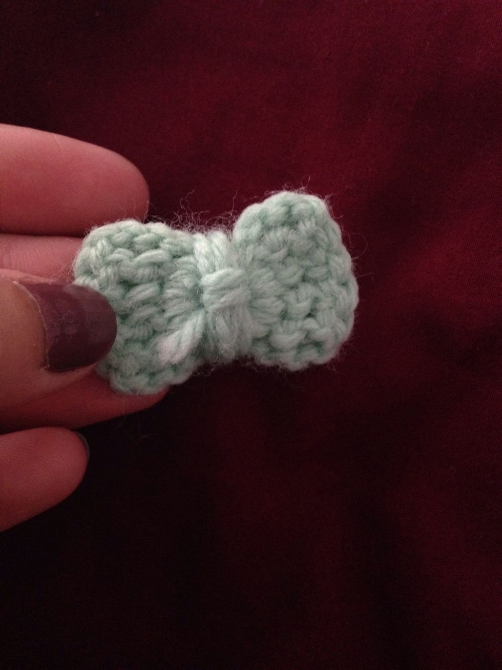 Wrap yarn around center several times and tuck extra yarn in the back.