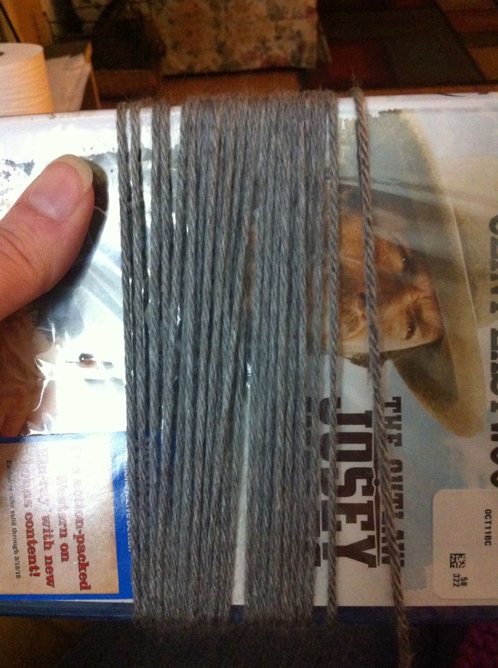 Wrap yarn around DVD one time for each piece of fringe you need. Shhh don't tell hubby I used his Clint Eastwood movie!  He already got upset when I used his coffee mug as a guide for a mug cozy.