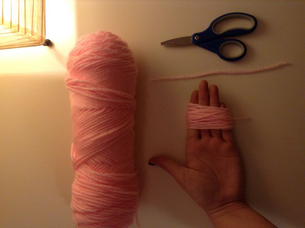 Wrap yarn around fingers and cut a piece if yarn about 5 inches
