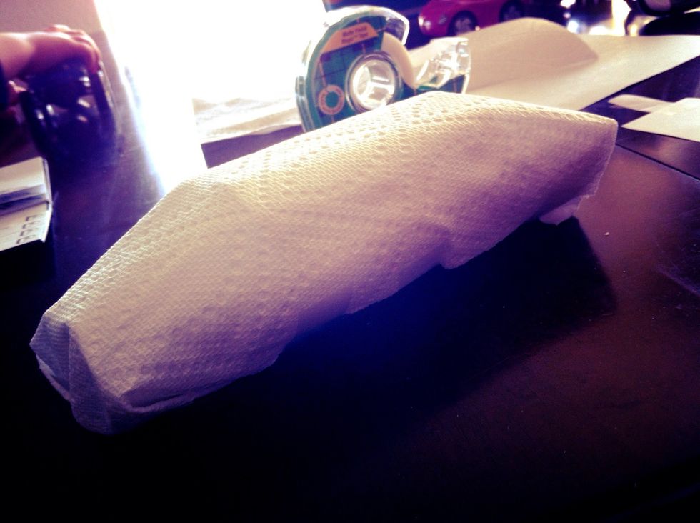 Wrap your frame with a paper towel or other soft, foldable paper. Tape it on the bottom. Now you have a blank car canvas to decorate!