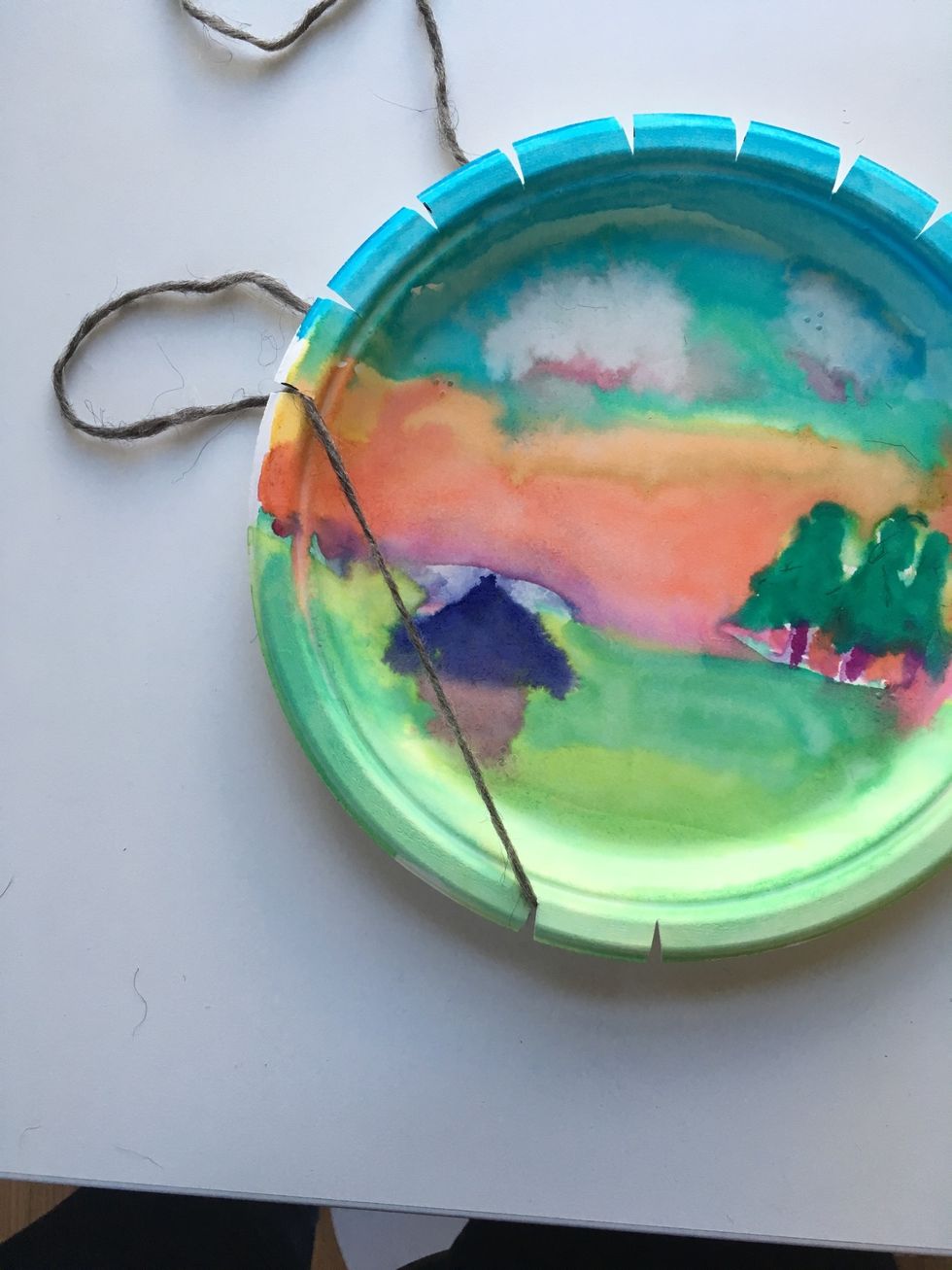 Wrap your yarn LOOSELY to the first slot on the left on the top of your plate.