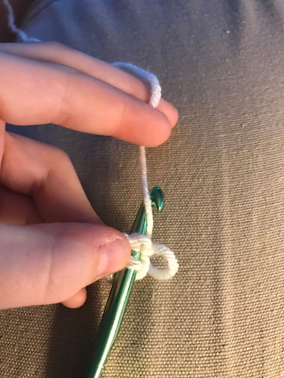 Wrap your yarn over the crochet hook and pull both lips through. This method is called a slip stitch