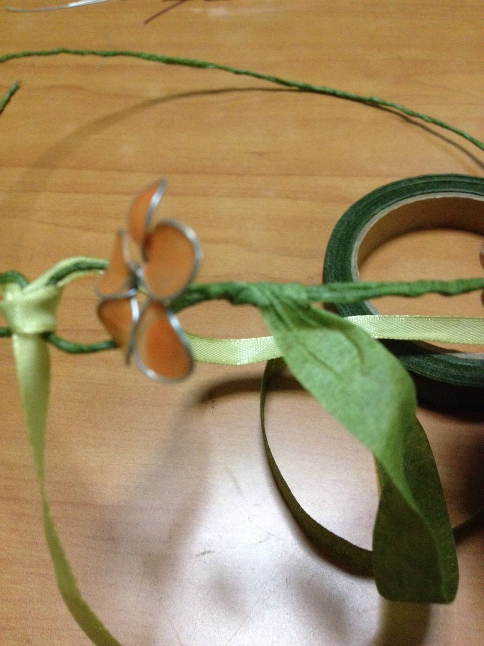 wreath. Attach the flowers from the loops onwards to the centre of the wreath. Place the flower and allow for a short length of the stem to be exposed.