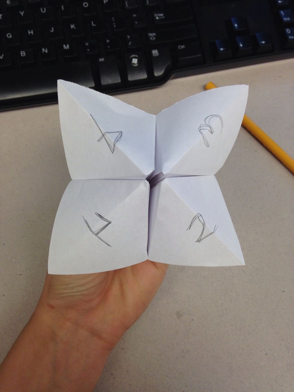 Write numbers 1-4 on the four claps. Flip it over, and write 8 colors on the triangular flaps.