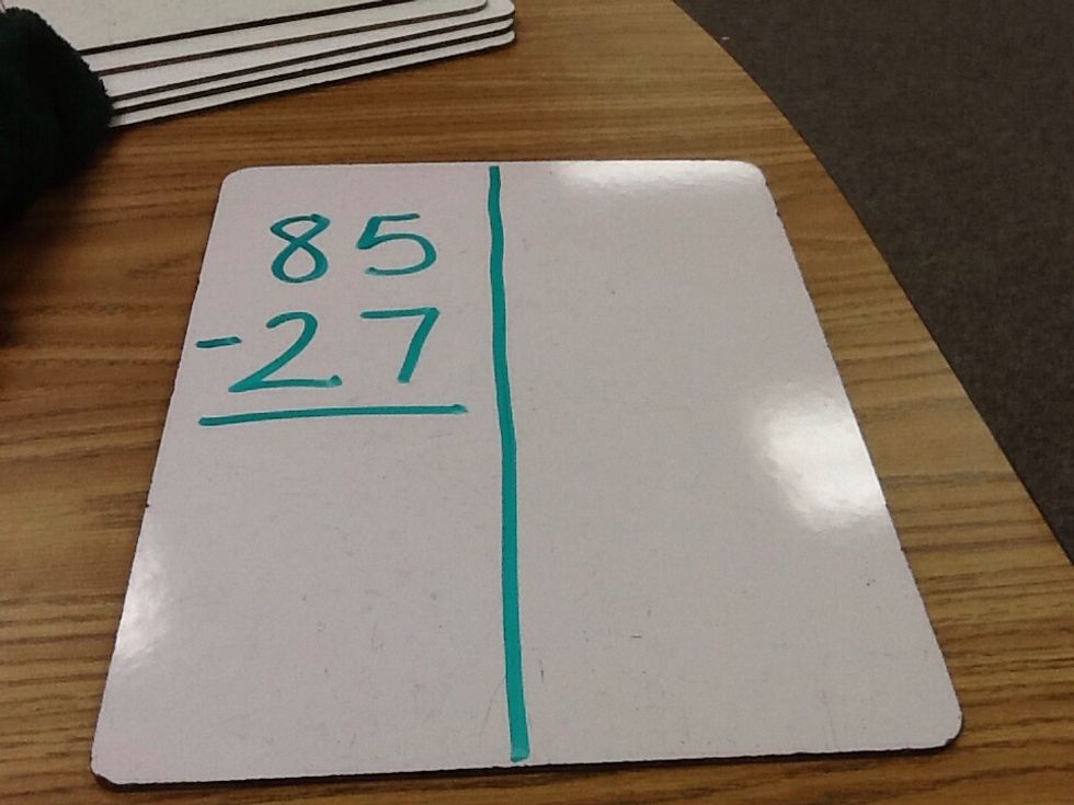 Write your math problem on one side of the whiteboard.