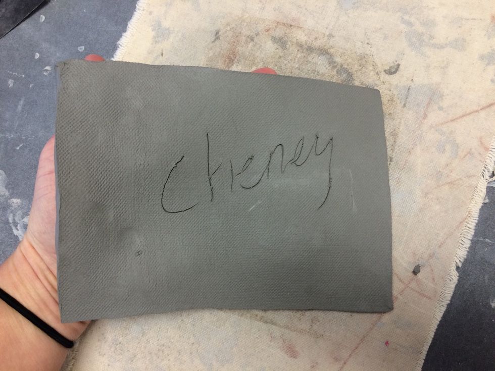 Write your name on your clay lightly with the needle tool and flip it over.