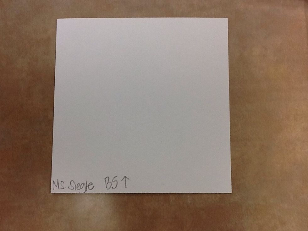 Write your name small on backside in case you mess up so you can still flip your paper over. Then write the number and letter that is on the back of the small mystery square on your big square paper.