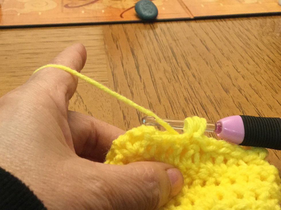 Yarn over and go through the same tops and pull loop through all 3 loops to