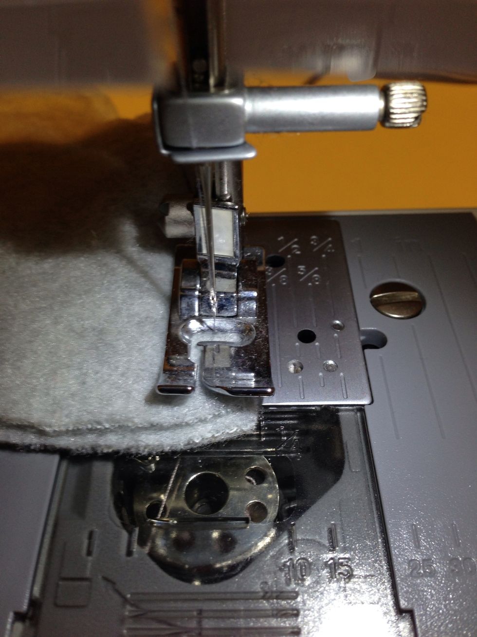 Yeah near the tip slowed down and let the needle stick all the way through when ur at the tip. Ur then going to lift the foot (the part holding down the fabric) and pivot the ear to the other side wee