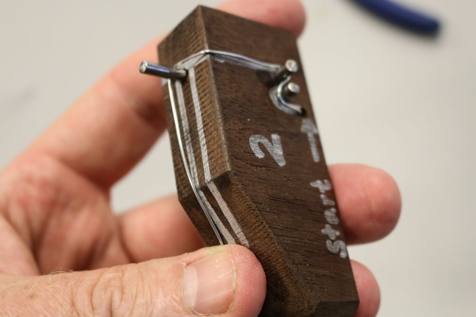 You are following the same path just with opposite bends. Bend over the top and following the previous direction, trim extra wire off.