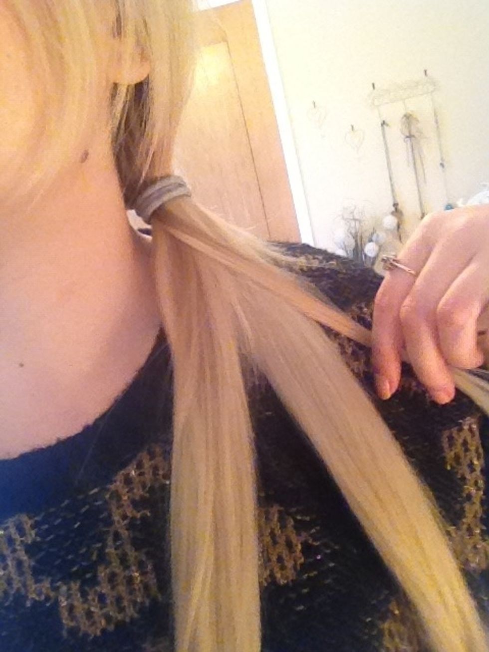 You are going to take this small amount and cross it over to the other section. TIP: hold a section in each hand and take a firm grip to hair being crossed over