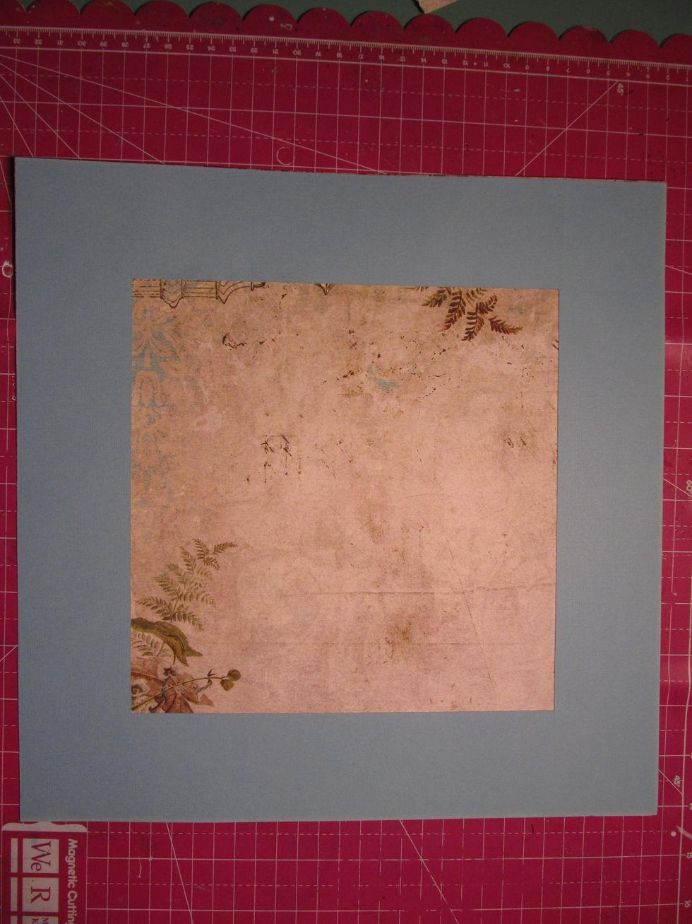 You are going to use the outside square to adhere to the back of your patterned paper. Save the inside square because we will be using that as well.