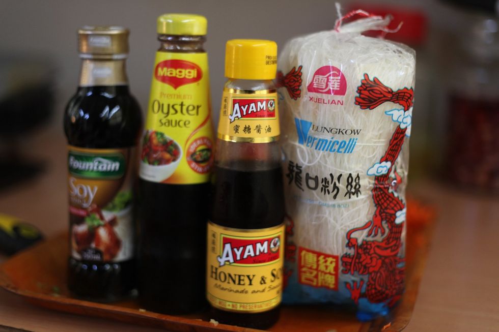 You Asian pantry should consist of light soy sauce, honey and soy, oyster sauce and dried vermicelli noodle. It's a very cheap rice noodle, when cooked it should look glassy. Let's get started.