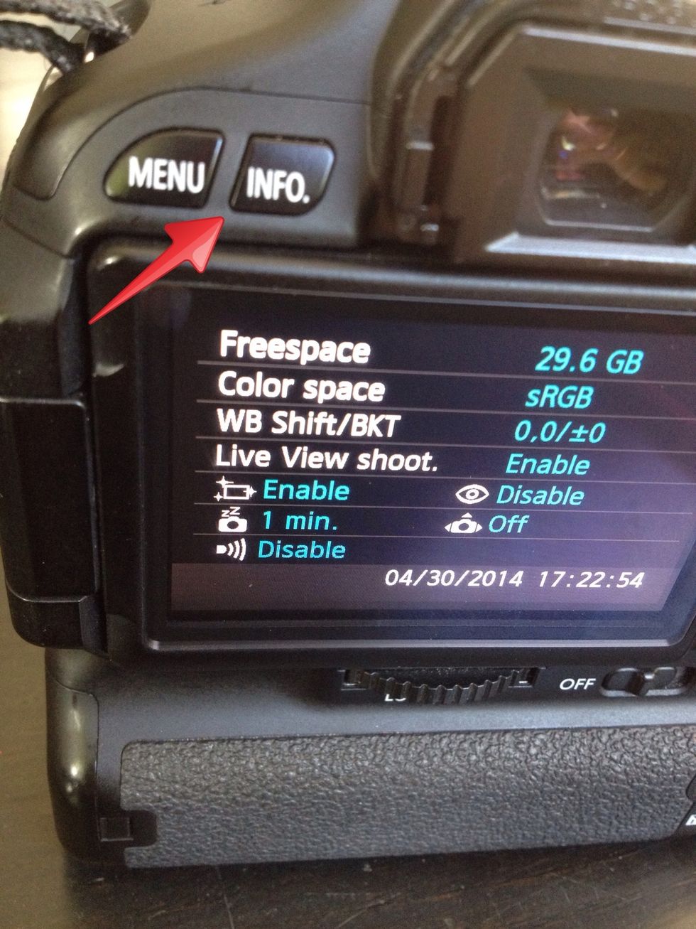You can access the information screen by pressing the info button to the left of the viewfinder