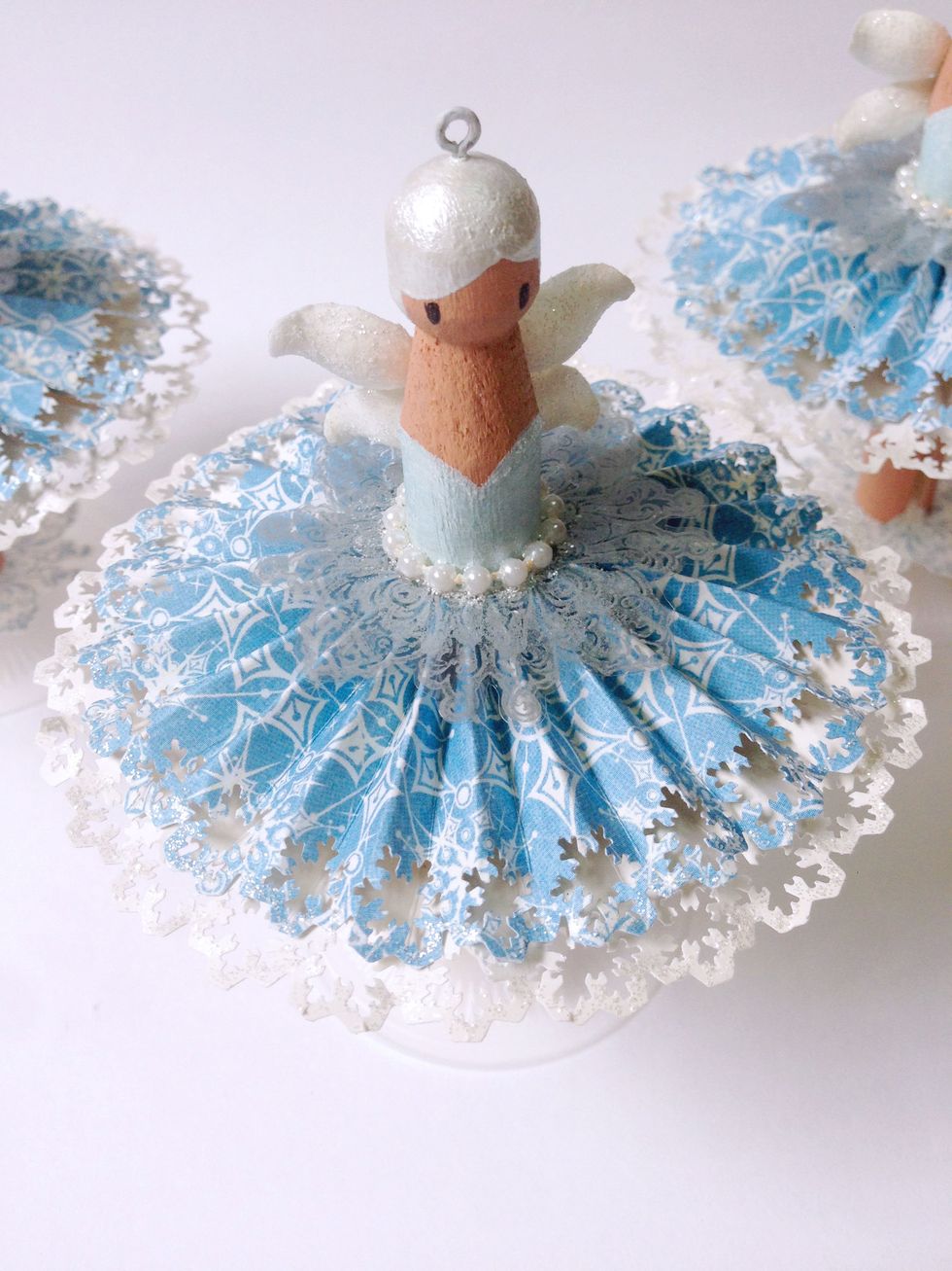 You can add some pearl accent on the fairy's waist... To hang as ornaments, insert a screw eye bail at the head of the dolly peg as shown...