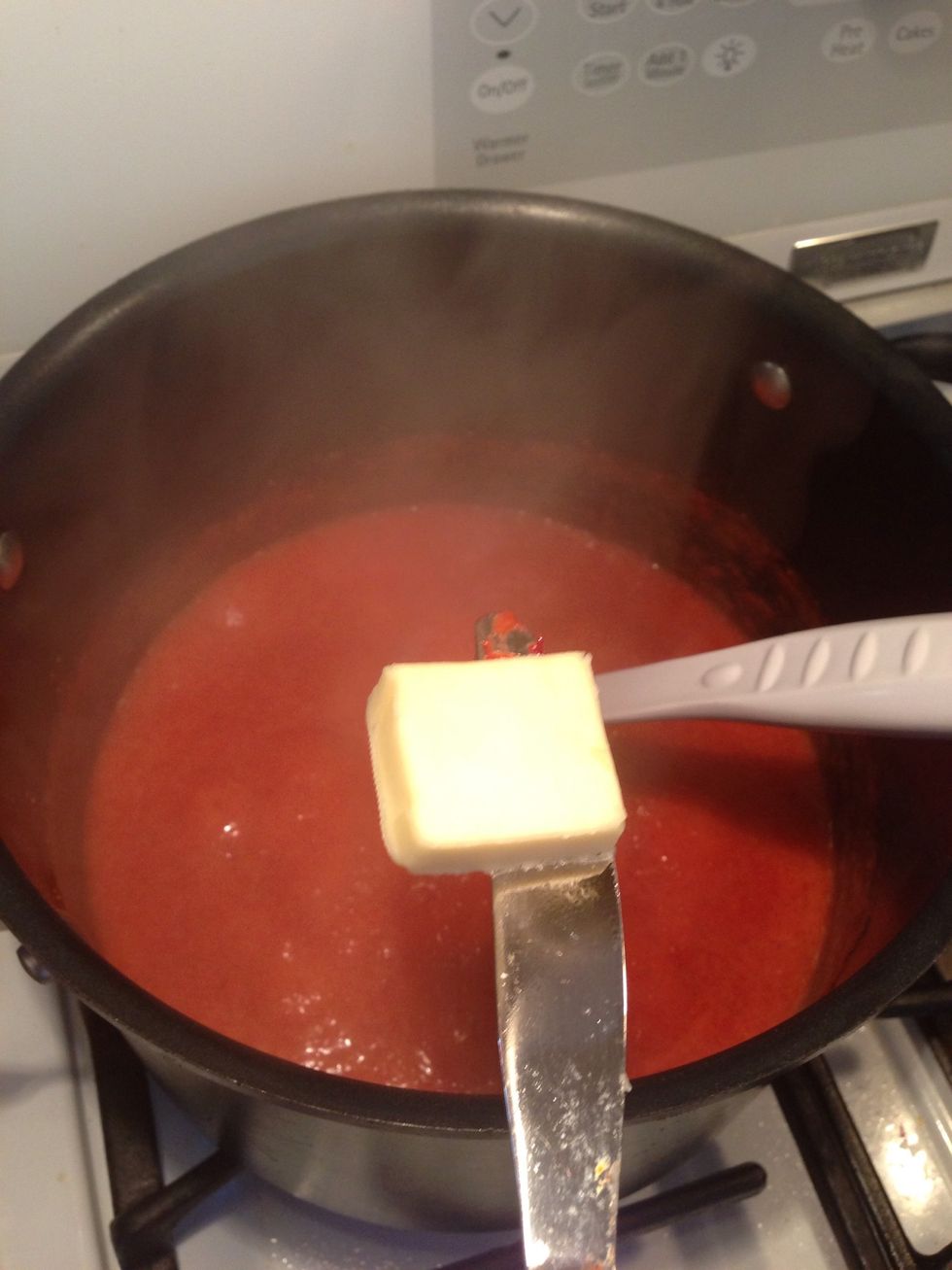 You can add the butter (keeps the foaming down so you don't have to skim it later) and lemon juice (citric acid is a preservative) any time. If you skip butter you may need to skim foam before canning