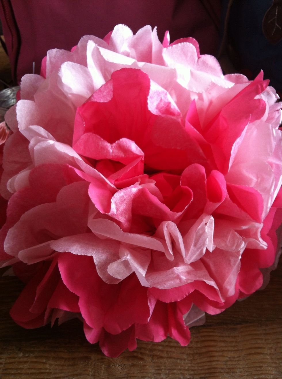 You can also experiment and create contrasting coloured pom poms. We created this two tone pink pom pom by alternating the coloured tissue paper in step 1.