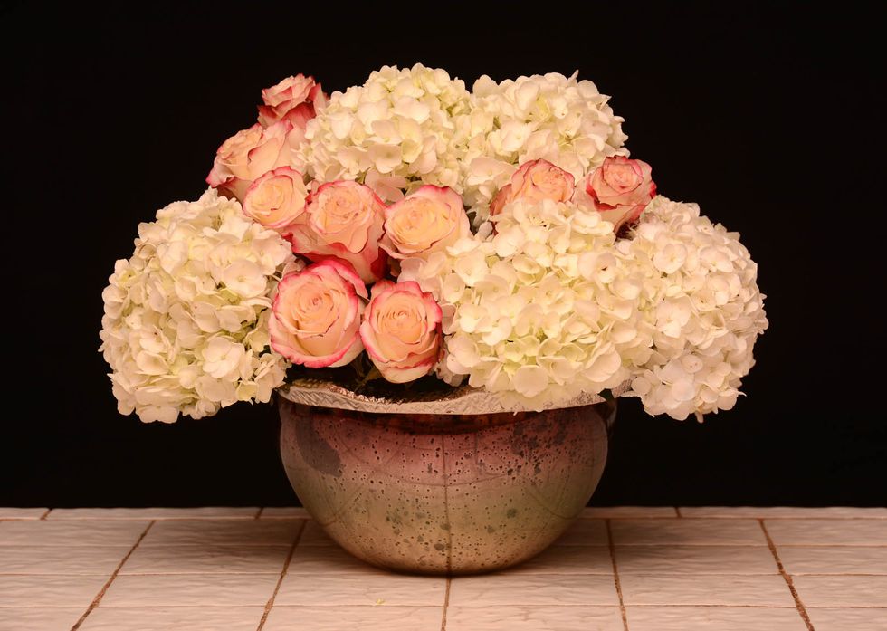 You can also place roses in-between the top two hydrangea and the round circle at the base. This arrangement is created to be viewed all around\u2026Roses can be on one side or extended all way around.