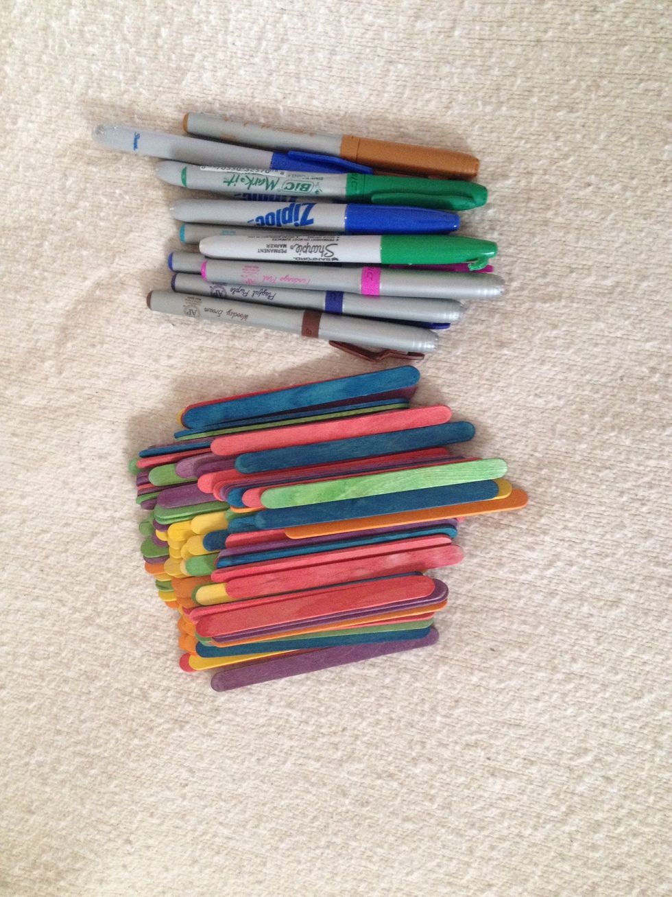 You can buy colored Popsicle sticks or use permanent markers to color them. Then, just use darker colors to write on the sticks. Craft stores sell skinny and larger sticks plain and colored.