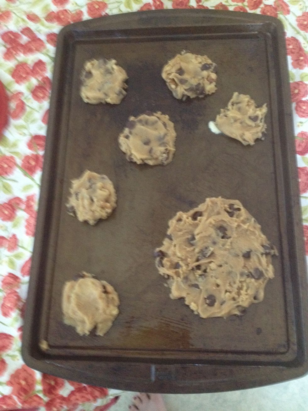 You can create tiny cookies or a giant one like this. You can press them down slightly for thinner, crispier cookies. Or leave them thick for chewier cookies.