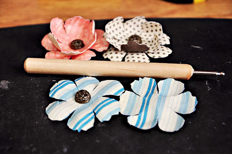 You can curl it upwards or downwards and make it a little bit shabby/tattered. Finish of with a piece of metal brad.